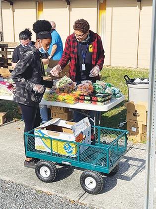 An Interlachen JROTC cadet sorts food to be given out to the community.