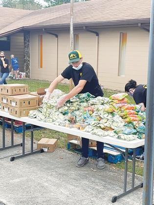 JROTC cadets at Interlachen High School gather food last week to give to families in need for a community service project at First Baptist Church of Interlachen.