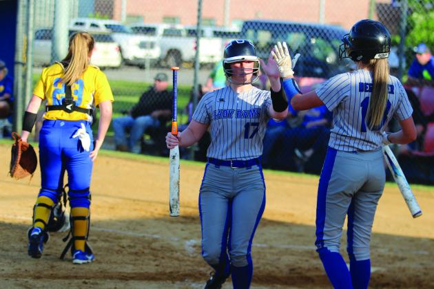 Interlachen’s Halie Gutierrez (left) is greeted by teammate Briana Degeyter after scoring the first run of the game on a Janae Green double in the second inning. (MARK BLUMENTHAL / Palatka Daily News)
