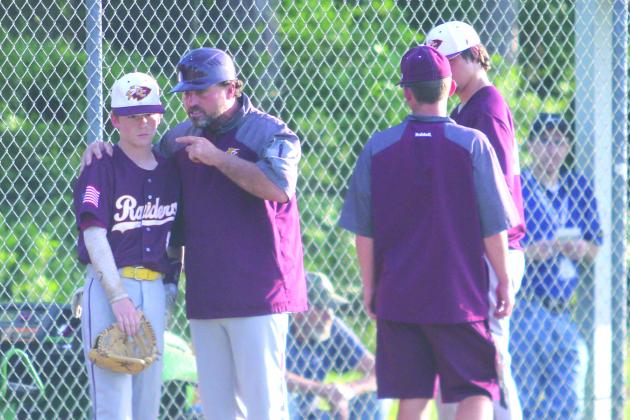 Crescent City High baseball coach Tim Ross, at left, gives encouragement to Raiders second baseman Camron Boyle during last week’s District 8-1A victory against Wildwood. (MARK BLUMENTHAL / Palatka Daily News)
