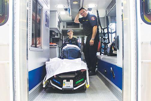 Putnam County Emergency Services employees Matt Moriarty and Lt. Damon Rust test the AutoPulse devices on an ambulance emergency kit Thursday.