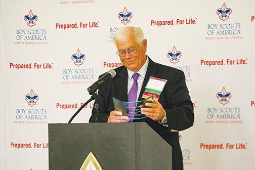 Lifetime Putnam County resident Bill Herrington looks at his award during the Palatka American Values Dinner on Thursday, where he was recognized for his decades of service to the county.
