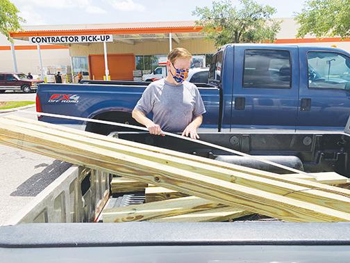 Robert Anderson purchases timber from Home Depot in Palatka in the days leading up to Hurricane Isaias in August 2020.