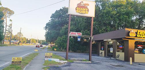 Signs in front of Larry’s Giant Subs in Palatka advertise the restaurant’s need for additional employees Monday afternoon.