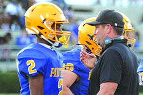 Palatka’s Roderris Passmore (2) discusses strategy with new head coach Patrick Turner during Tuesday night’s 41-21 loss to Nease. (MARK BLUMENTHAL / Palatka Daily News)