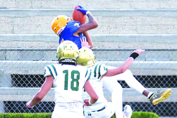 Palatka’s Jamal Bryant leaps up to catch a second-quarter touchdown over an unidentified Nease defender Tuesday night. (MARK BLUMENTHAL / Palatka Daily News)