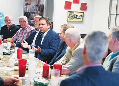 Gov. Ron DeSantis chats with local political and business leaders earlier this month at C P Deli in Palatka.