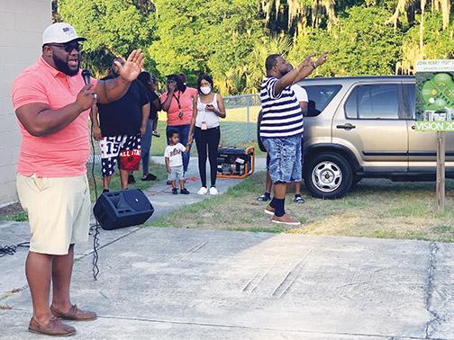 Quan Proctor sings during a vigil at Booker Park held in response to two Palatka men getting killed in unrelated shootings Sunday and Tuesday.