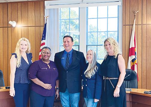 After being sworn in to office Thursday, Welaka Town Councilwoman Kathy Washington stands with Mayor Jamie Watts, Councilwoman Marianne Milledge, Councilwoman Tonya Long and Council President Jessical Finch.