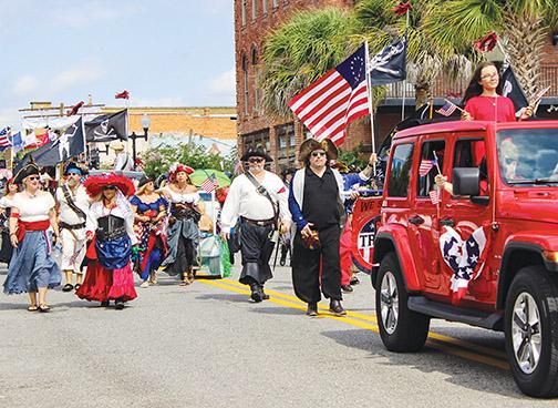 Members of a St. Augustine historical re-enactment group march down St. Johns Avenue in Palatka on Monday to recognize fallen soldiers during the Memorial Day Parade.