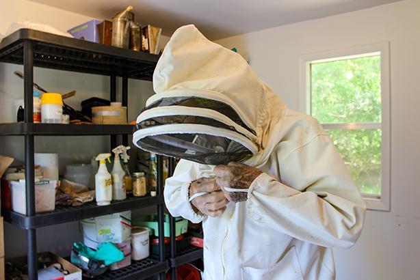 Ray Merrill, 92, suits up in gear to protect him from being stung as he prepares to take care of his backyard honeybee hives.