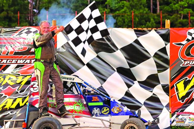 John Crowder stands with the checkered flag in victory lane after winning the non-wing mini sprints class at Church in the Dirt at The Clip at Putnam Raceway on Sunday. (Submitted / The Clip at Putnam Raceway)