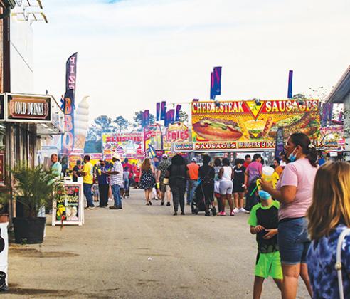 Fair attendees walk around the Putnam County Fairgrounds, which has been allocated $1.2 million from the state Legislature.