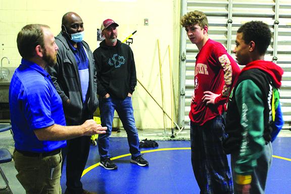 Palatka High School wrestling coach Josh White, left, and assistant coach Elysha Campbell, second from left, had memorable 2020-21 seasons. They chat with fellow assistant coach Richie Lewis, middle, and state wrestling qualifiers Brandon Lewis, second right, and Mikade Harvey in March. (MARK BLUMENTHAL / Palatka Daily News)