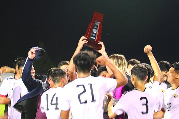 Members of the Crescent City High School boys soccer team celebrate with the District 4-3A trophy after beating Gainesville P.K. Yonge in the final, 4-3, on Feb. 9, at Keystone Heights High. (MARK BLUMENTHAL / Palatka Daily News)