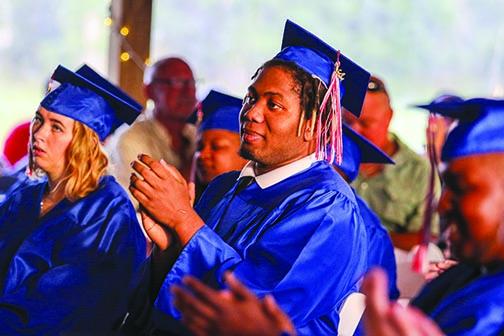 Putnam Edge High School graduate Kenne Eubanks claps for his fellow graduates Thursday evening during the ceremony held at Coventry Oaks Farm in Palatka.