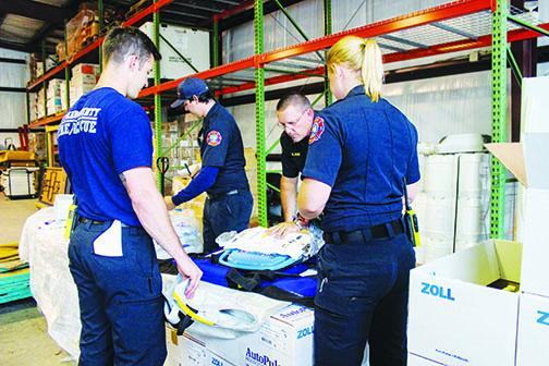 Putnam County Fire and Emergency Medical Services paramedics practice with automated CPR devices in May. First responders from county and city agencies are looking to upgrade to 800 MHz radios.
