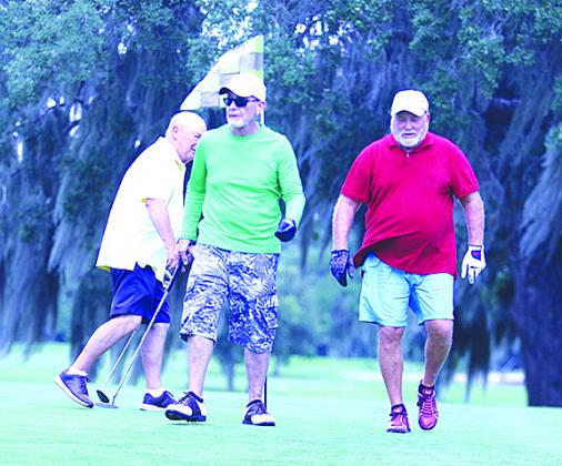 Don Kirby, John Anderson and Steve George walk off the sixth green during a round of golf at Palatka Golf Club on Tuesday. Golf.com recently ranked the course as the 29th best municipal golf course in the country.