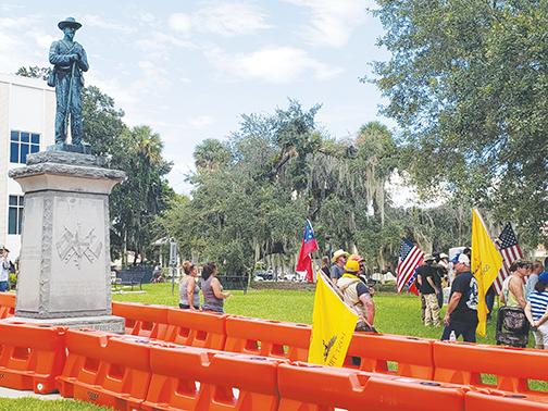 Protesters gather at the Putnam County Courthouse in August 2020 to advocate keeping the Confederate statue on the courthouse lawn.