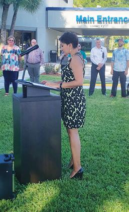 Leah Berry, Ahmad’s youngest daughter, becomes emotional as she talks about her father Tuesday during the dedication of the garden in his honor.