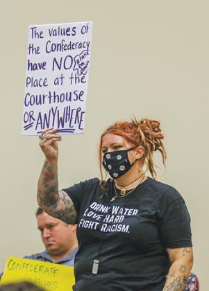 Interlachen resident Rikki Judson stands during a Putnam County Board of Commissioners workshop Tuesday to protest the Confederate monument at the Putnam County Courthouse