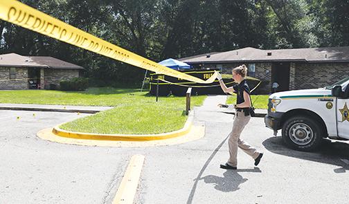 An investigator works the scene of a fatal shooting Tuesday in Crescent City.