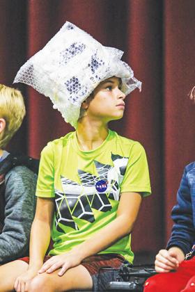 Zed Crowley, a fifth-grader, wears a brain-protective hat he made during STEM camp.
