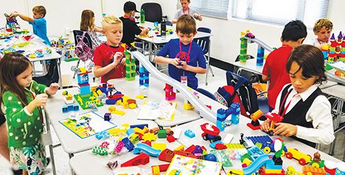 First graders play with LEGOs and construct buildings during STEM camp with the Putnam County School District last week