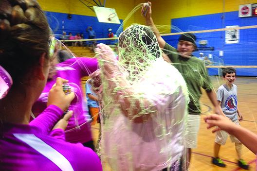 Peniel Baptist Academy volleyball coach Terry Goodwin is covered in Silly String by his players after the Warriors defeated Jacksonville Seacoast Christian for his 100th career win at Jenkins Middle School on Oct. 10, 2013. (Submitted photo)