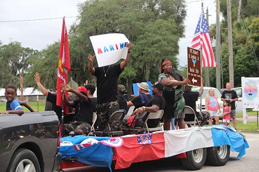 Family members of Robert H. Jenkins Jr. wave to event-goers during Interlachen’s parade Saturday.