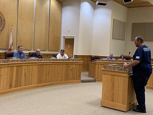 Putnam County commissioners listen to Executive Director of Public Safety J.R. Grimes, right, outline the county’s mobilization plan for Hurricane Elsa.