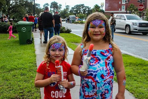 Dottie and Jorjann Solana eat popsicles while decked out in red, white and blue for the Fourth of July at the Palatka riverfront.