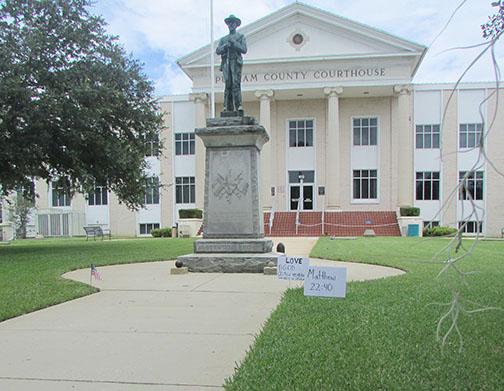 Balloons and signs at the Putnam County Courthouse on Sunday imply the Confederate statue on the lawn is a “golden calf.”
