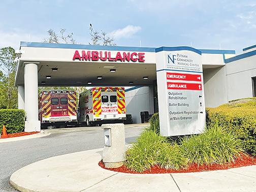 Ambulances wait in the emergency room patient dropoff area at Putnam Community Medical Center early Tuesday evening.