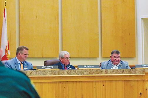 County Commissioners Larry Harvey, Bill Pickens and Jeff Rawls discuss a monument protection ordinance during a meeting Tuesday morning.