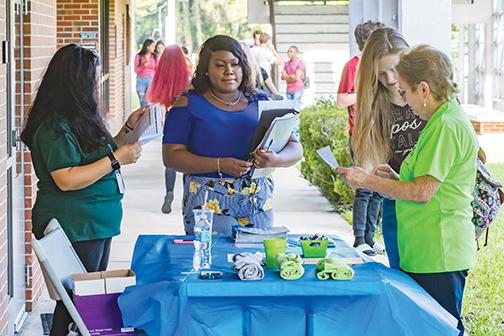 St. Johns River State College employees help students find their way around campus at the start of the fall 2019 semester.