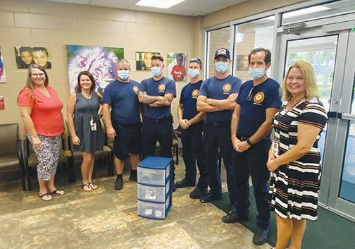 Palatka Fire Department employees donate school supplies to Mosley Elementary School on Thursday before going to three other elementary schools.