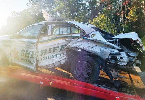 A Putnam County Sheriff’s Office patrol vehicle is loaded onto a tow truck after being involved in a crash.
