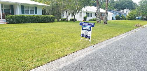 A sign on Laurel Street marks a house for sale in Palatka.