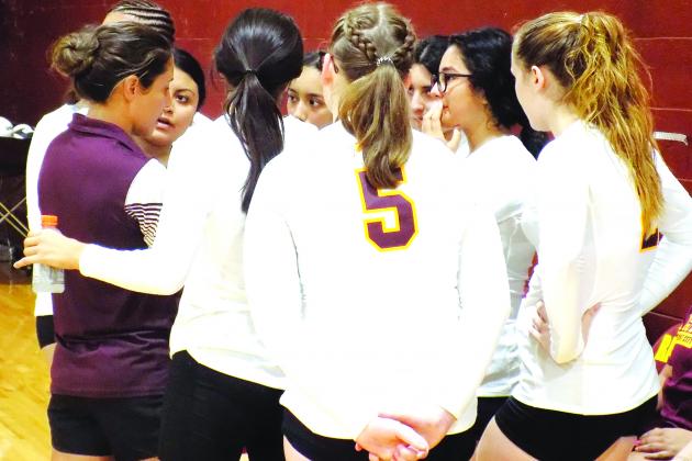 Crescent City Jr.-Sr. High School volleyball coach Ashley Jones (left) talks to her players during a timeout in the Raiders’ sweep of Peniel Baptist Academy on Tuesday. (COREY DAVIS / Palatka Daily News)