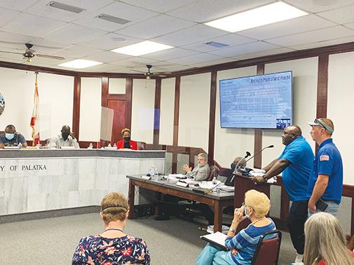 Palatka Community Affairs Director Eddie Cutwright and Facilities Maintenance Manager Justin Bridges discuss maintenance of city properties with commissioners at Thursday night’s meeting.