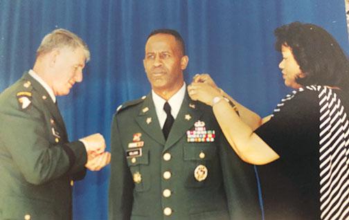 Darlene Williams pins her husband, Army Col. Thomas Williams, to signify his colonel rank with Maj. Gen. Robert Van Antwerp in attendance at the Pentagon in 2001 prior to the 9/11 attack.