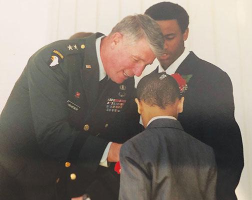 Maj. Gen. Robert Van Antwerp pins Army Col. Thomas Williams’ sons with a miniature colonel rank insignia during a 2001 ceremony at the Pentagon.
