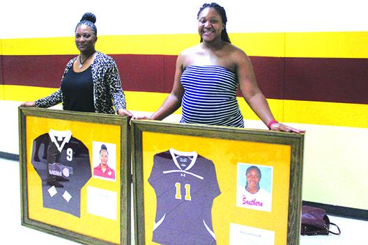 Standout volleyball players Yolanda Simmons Brady, left, and Kayshia Brady, all-American players in college, had their numbers retired by the school. Kayshia Brady was the state 1A player of the year of the 2011 Raiders Final Four team. (MARK BLUMENTHAL / Palatka Daily News)