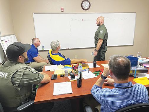 Members of the Putnam County Sheriff’s Office and Palatka Junior-Senior High School administration discuss pickup and drop-off routes in August.