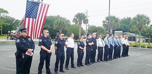 Emergency personnel forms a line during a moment of silence Saturday during the Sept. 11 Remembrance Ceremony in Palatka.
