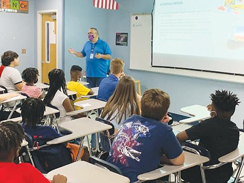 A teacher and students get down to business on the first day of classes at Palatka Junior-Senior High School.