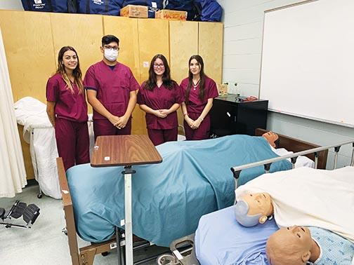 Crescent City High students Elianna Ramirez, Emanuel Lopez, Malia Garcia and Melanie DeLeon prepare to practice CPR on some of the program’s mannequins.
