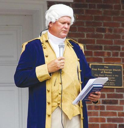 East Palatka resident Johnny Counts dresses as George Washington and talks to the crowd of residents gathered in downtown Palatka on Friday.