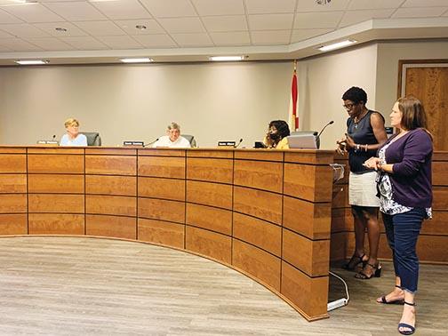 Putnam County School District Lead Clinical Therapist Stephanie Wellon and Community Relations Director Ashley McCool present board members with information about mental health Tuesday.
